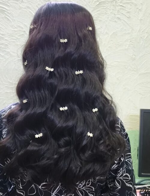 Soft curled hairstyle by professional hairstylist at Noor Luxe Studio
