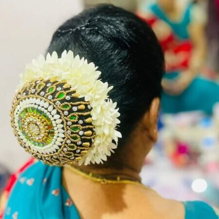 Traditional bridal bun hairstyle with fresh flowers